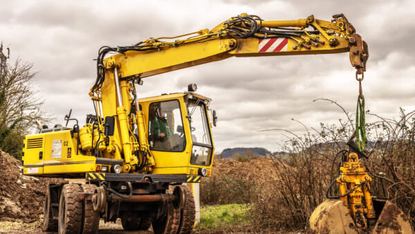 Excavator in field