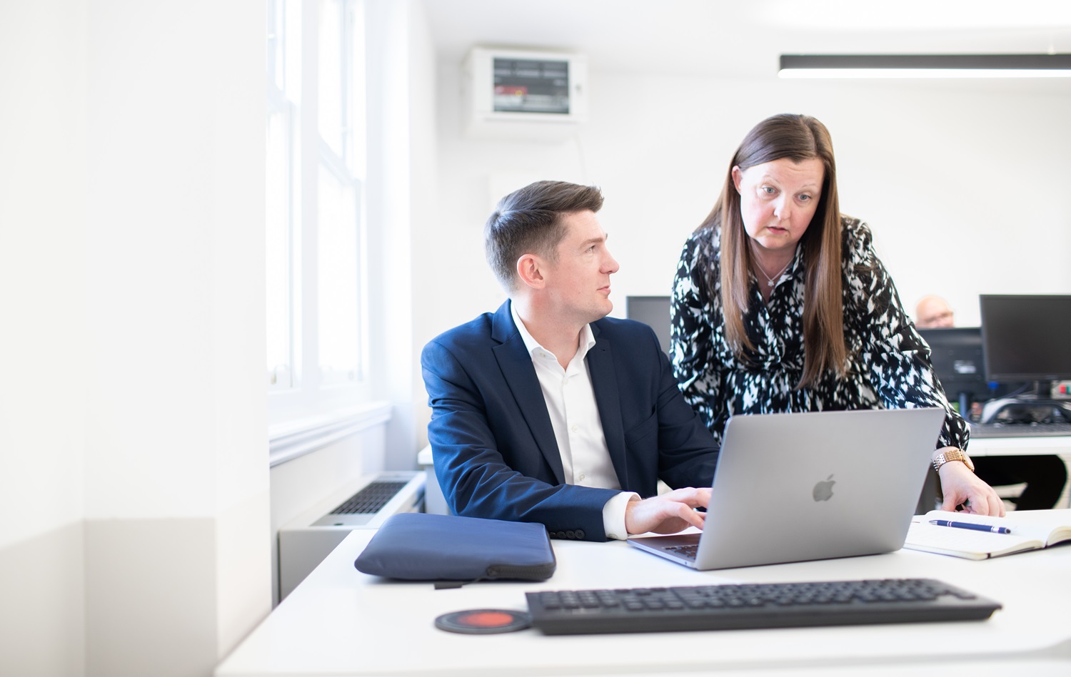 Building consultants at laptop in conversation